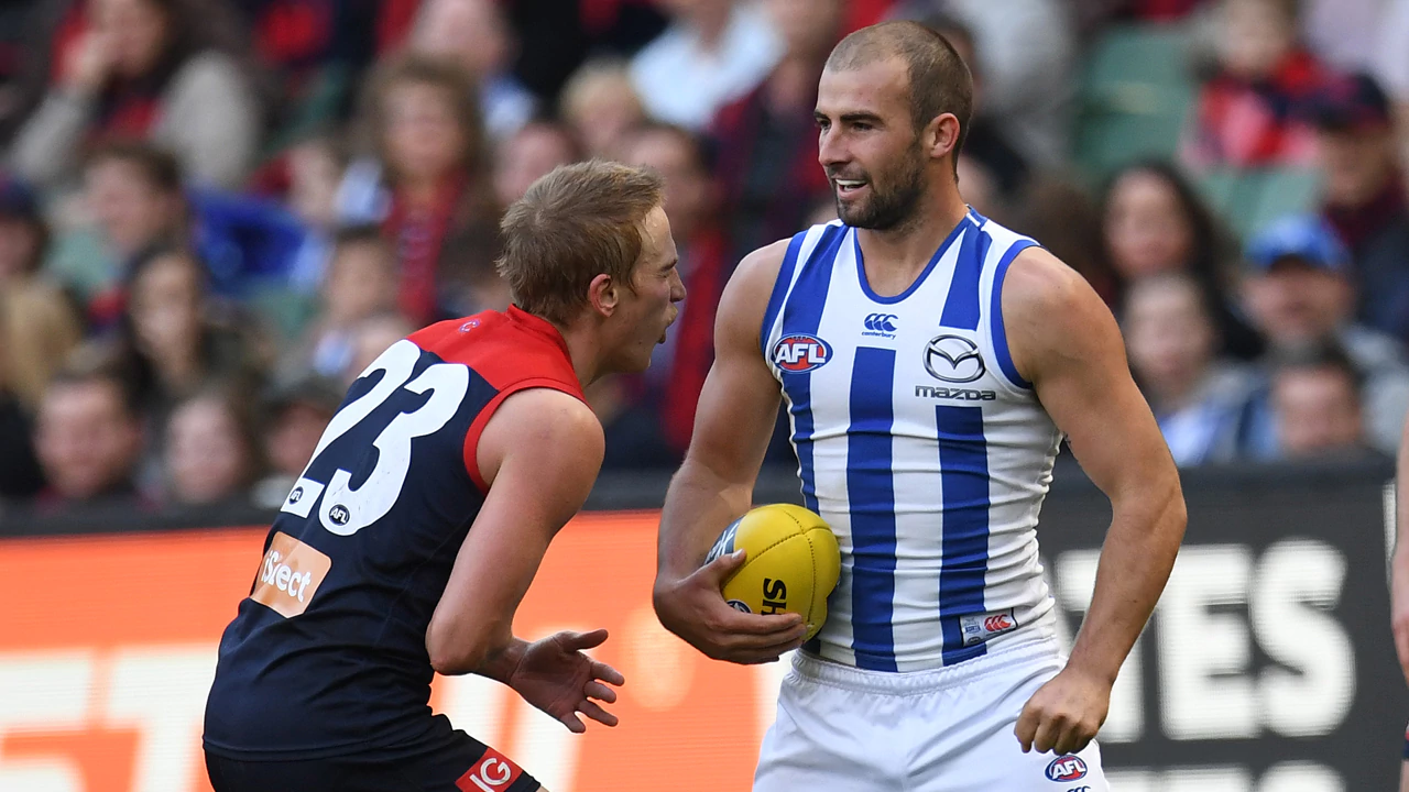 Melbourne's Bernice Vince on the other end of North Melbourne's Ben Cunnington's jumper punch, Round 9. AFLJumperPunch Ben Cunnington North Dees
